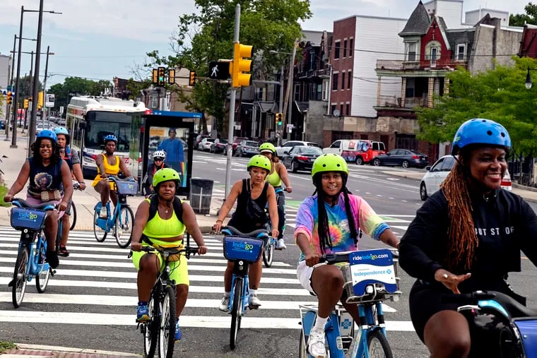 Participants in the Black Girl Joy Bike Ride travel 33rd Street, along part of the legendary Boxers’ Trail in North Philly Sunday, Aug. 11, 2024. Iresha Picot (not shown) founded the group for Black women bike riders and hosts the meet up every other week to ride with each other and build community.