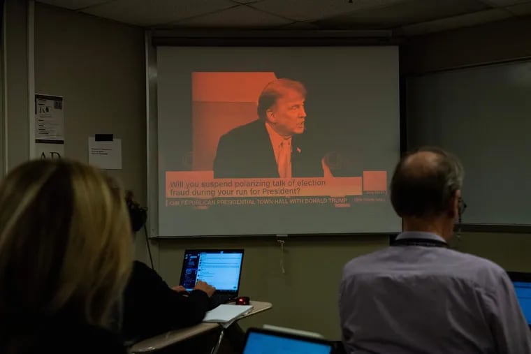 Reporters watch a CNN town hall with former U.S. President and 2024 presidential hopeful Donald Trump at St. Anselm College in Manchester, New Hampshire, on Wednesday, May 10, 2023. (Joseph Prezioso/AFP/Getty Images/TNS)