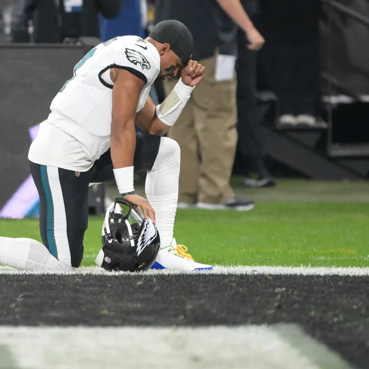 Philadelphia Eagles quarterback Jalen Hurts kneels before the start of the season opener in Brazil. On Wednesday, Frankie Beverly, one of Hurts' favorite artists, passed away.