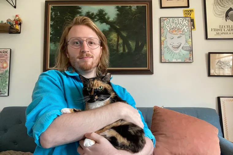 Dave Cline with his cat Peach. The West Philly man rented a billboard to find a date.