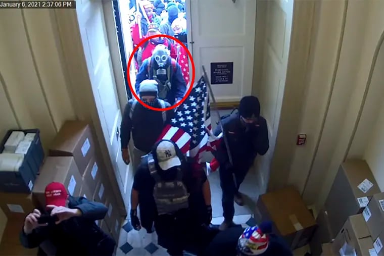 This image from video from the Justice Department in the statement of facts supporting an arrest warrant, and annotated by the source, shows Dan Edwin Wilson, circled in red, entering the U.S. Capitol on Jan. 6, 2021, in Washington.