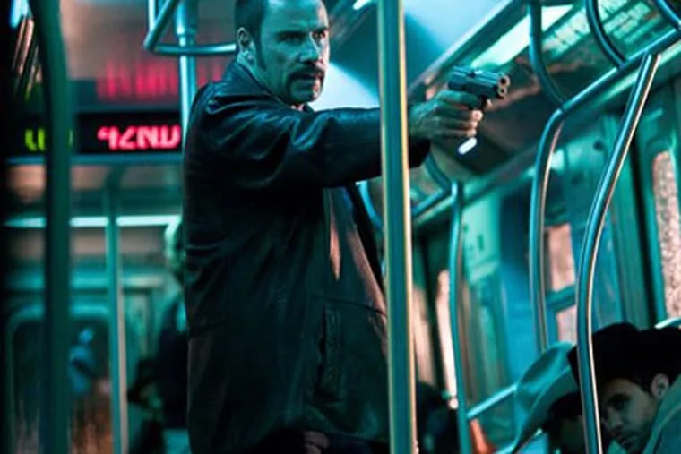 John Travolta as Ryder, the leader of a band of bad guys that seizes a
New York subway car and takes the passengers hostage.