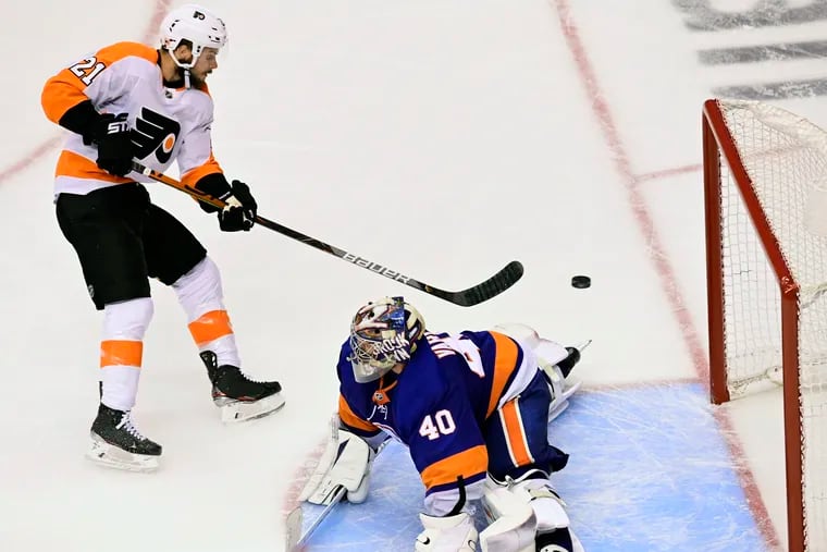 Flyers center Scott Laughton scoring on New York Islanders goaltender Semyon Varlamov in the third period  to tie Game 6 of the conference semifinals. The Flyers won in double overtime.