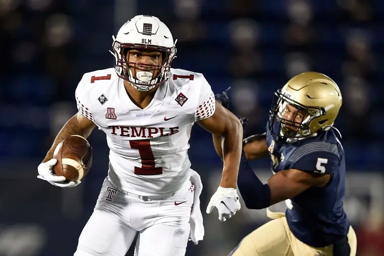 Temple's Branden Mack runs the ball as Navy's Michael McMorris gives chase in the first half.