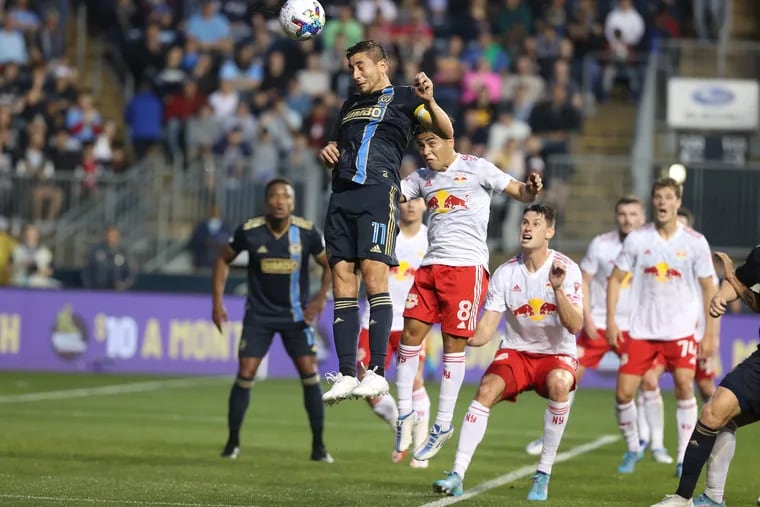 Alejandro Bedoya (center) goes up for a header during the Union's 1-1 tie with the New York Red Bulls at Subaru Park in May.