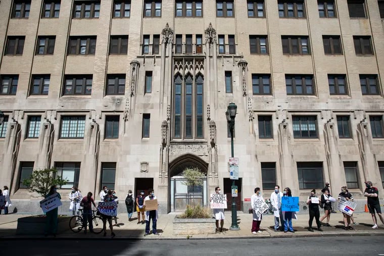 People protest outside of the shuttered Hahnemann Hospital.