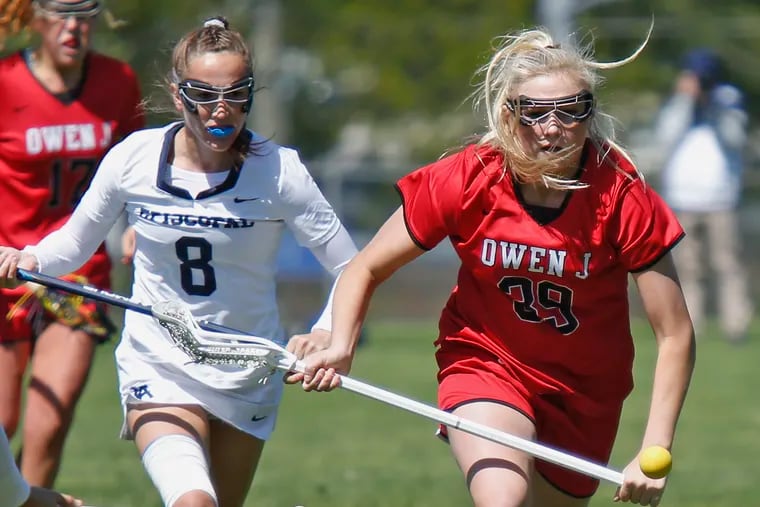 Hannah Delahaye (right) of Owen J. Roberts and Isabelle Rohr of Episcopal Academy eye a loose ball during the first half at the Katie Samson Lacrosse Festival on Saturday, April 27, 2019 at Radnor. Episcopal went on to win, 16-12.