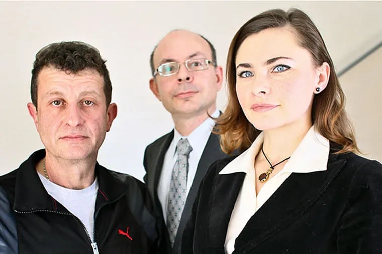 Immigration attorney Francois-Ihor Mazur, center, his wife and assistant Iryna Mazur, right, and their client Semyon Bluzer at Mazur's law offices in Feasterville Pa., on Monday March 31, 2014.  (Joseph Kaczmarek/For the Daily News)