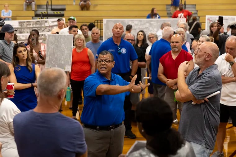 Glassboro, N.J., Mayor John E. Wallace III during an open house about the proposed Route 322 bypass Wednesday evening. Several in the crowd of about 150 people at Glassboro High School demanded that he speak.