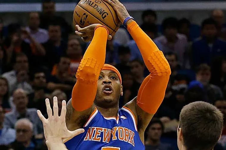 New York Knicks' Carmelo Anthony hold out three fingers on his