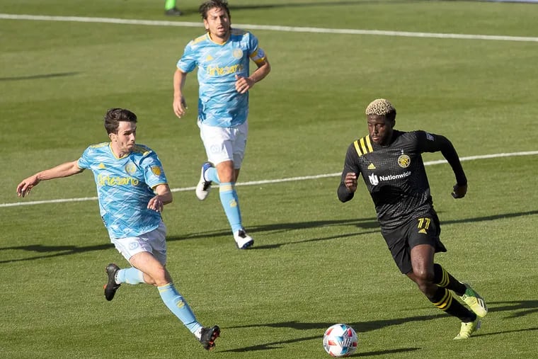 Leon Flach, left, battles for the ball against Gyasi Zardes, right, as Alejandro Bedoya looks on from behind during the Union's scoreless tie in Columbus on Sunday.