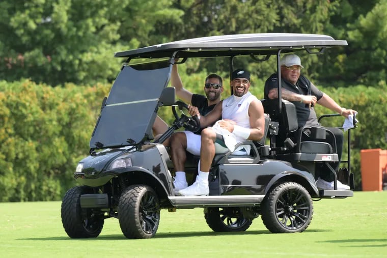 Eagles QB, Jalen hurts drive Nick Sirianni, left, and Dom DiSandro, right, off the field on Monday, Aug 5, 2024, at the end of practice at NovaCare Center in Philadelphia, Pa.