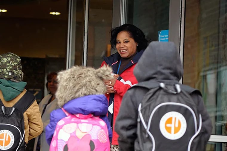 Darlene Davis, principal at Widener Partnership Charter School in Chester, greets students at the door as the come to school in the morning. November 12, 2013 ( RON TARVER / Staff Photographer )
