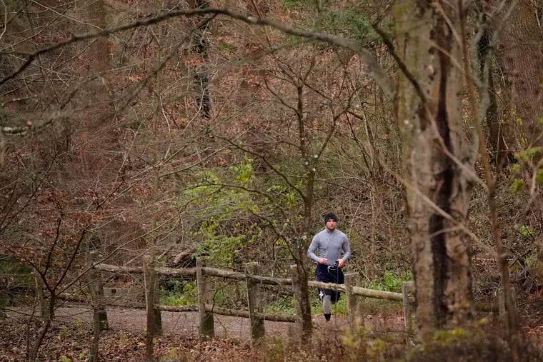 A man jogs through Wissahickon Valley Park in Philadelphia.