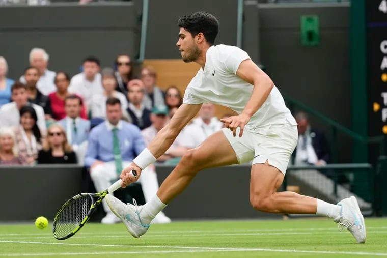 Carlos Alcaraz of Spain plays a forehand return to Tommy Paul of the United States during their quarterfinal match at the Wimbledon tennis championships in London, Tuesday, July 9, 2024. (AP Photo/Kirsty Wigglesworth)