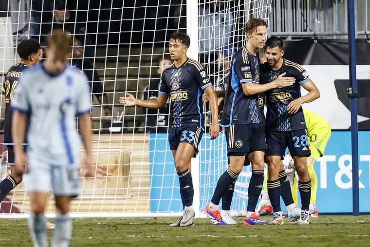 Tai Baribo (right) celebrates with teammates after scoring his first goal.