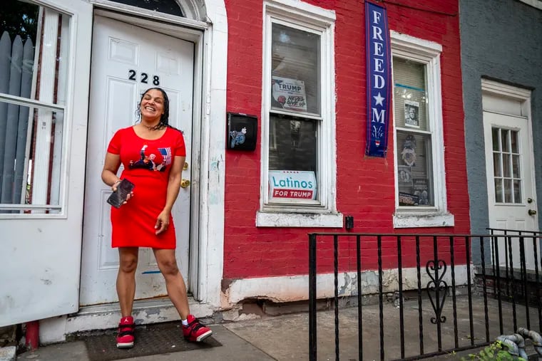 Rafaela Gomez of Reading stands outside her home, which is decorated with signs in support of former President Donald Trump. She said she feels like "the only Trump supporter in Reading," even as the GOP has made gains in the area.