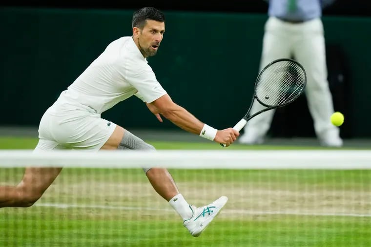 Novak Djokovic of Serbia plays a backhand return to Holger Rune of Denmark during their fourth round match at the Wimbledon tennis championships in London, Monday, July 8, 2024. (AP Photo/Mosa'ab Elshamy)