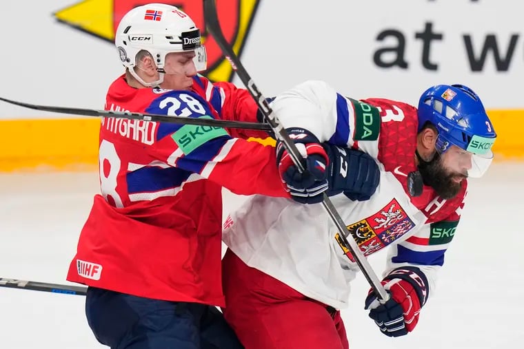 Norway's Michael Brandsegg-Nygard (left) hits Czech Republic's Radko Gudas during a preliminary round match at the World Championships on May 11.