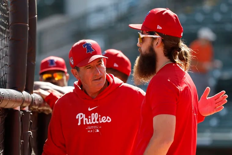 In order to play every day, "you’ve got to be able to hit the lefties — a little bit, anyway,” Rob Thomson (left) says of Brandon Marsh.