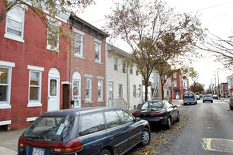 Racist remarks were spray-painted inside home (far left) in Port Richmond.