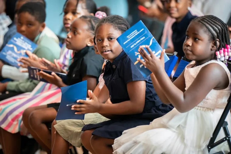 Cassidy Elementary students applaud at the opening dedication ceremony of their new school on Friday.