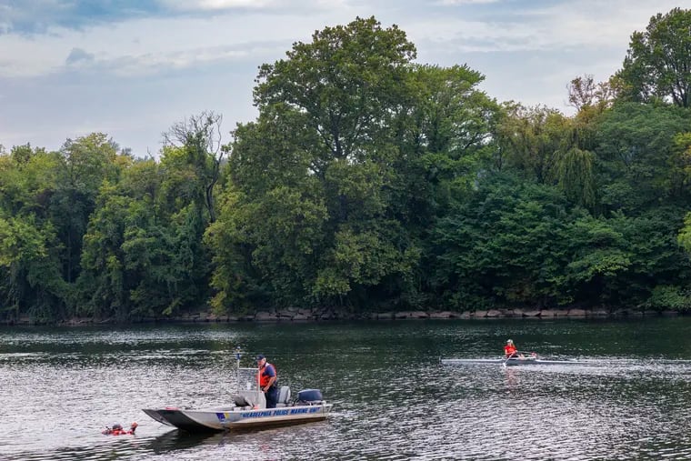 Philadelphia police Marine Unit investigate a car in the Schuylkill River near the reviewing stand parking lot early Wednesday morning last month.