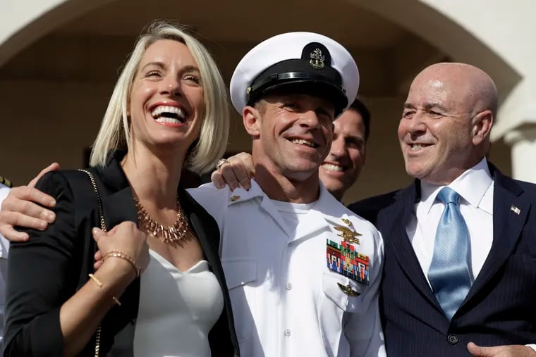 Navy Special Operations Chief Edward Gallagher walks with his wife, Andrea Gallagher, and adviser Bernard Kerik as they leave a military court on Naval Base San Diego, Tuesday, July 2, 2019, in San Diego.