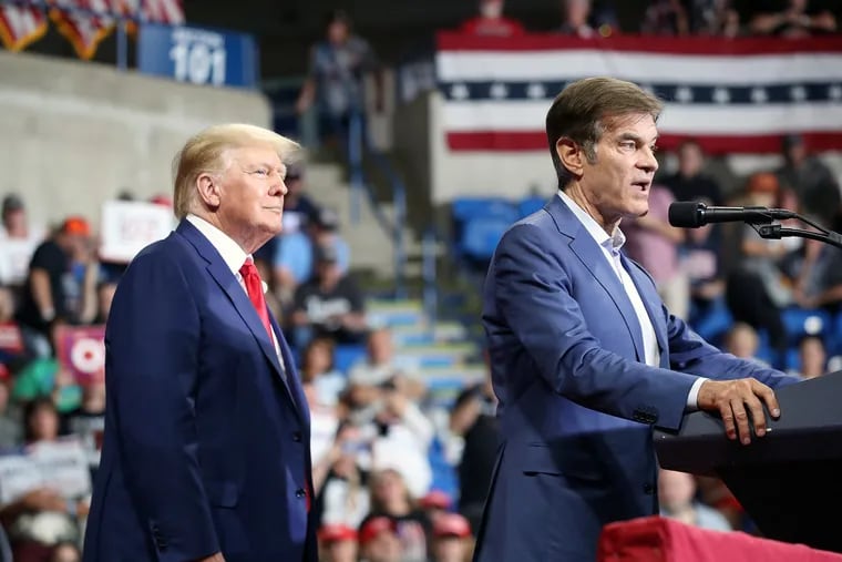 Pennsylvania Republican Senate candidate Mehmet Oz attends a GOP rally in Wilkes-Barre, Pa., with former President Donald Trump in September. When asked what he would do about Philadelphia's gun crisis, Oz pointed to the collapse of public education and said Congress should allocate funding for school vouchers.
