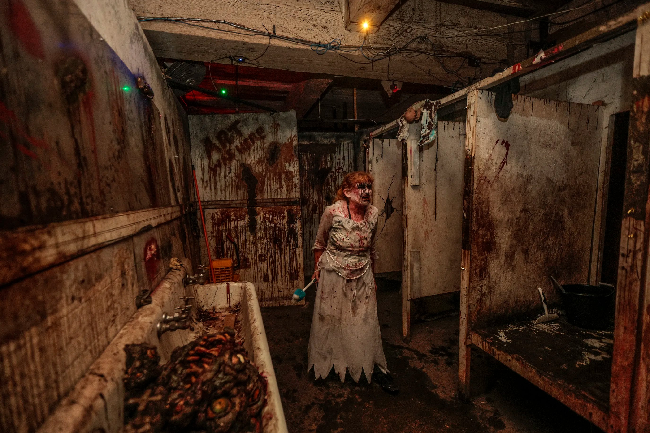 Charmaine Warrington, a 52-year-old haunter at Fright Factory in South Philly, at work, scaring visitors at the attraction. Friday October 6, 2023.