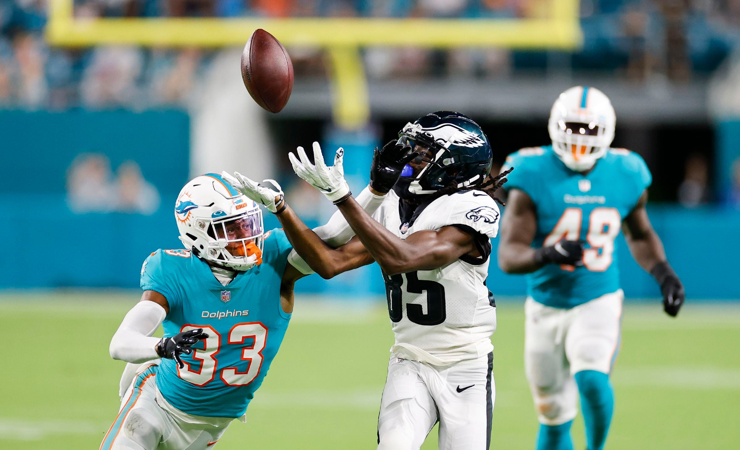 Philadelphia Eagles running back Jason Huntley (32) and quarterback Carson  Strong (8) greet each other as they warm up before the start of a NFL  preseason football game against the Miami Dolphins