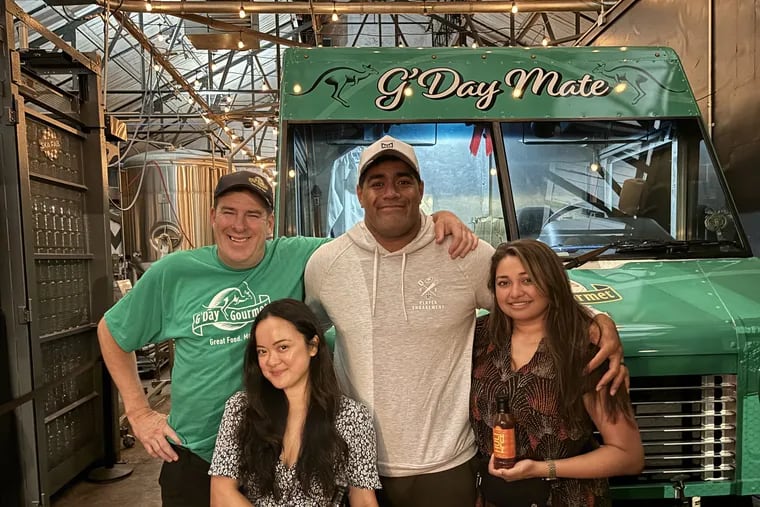 From left: Mike Peacock, Kiki Aranita, Jordan Mailata, and Niki Mailata in front of the G'Day Gourmet food truck at Love City Brewing, holding Aranita's Huli Huli sauce.