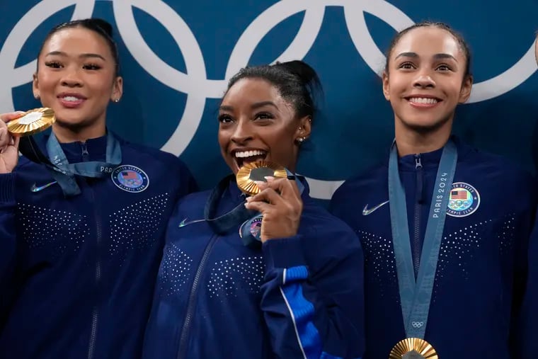 Fresh off winning gold in the women's gymastics team competition, Simone Biles (center) goes for gold in the individual all-around event on Thursday in Paris.