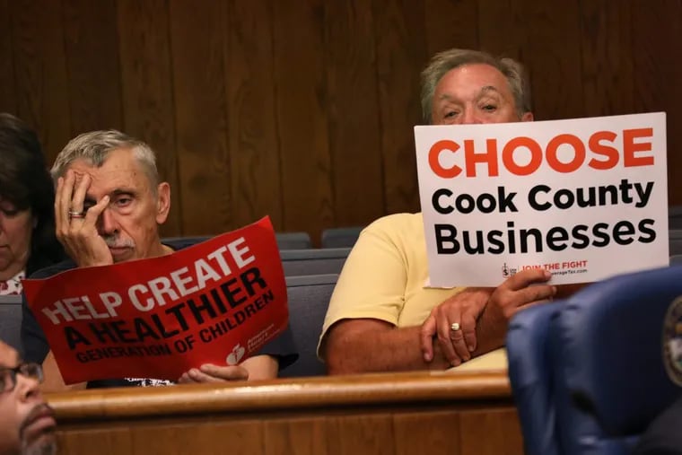 In Cook County, Illinois, a supporter of the beverage tax and an opponent sit side by side at a public meeting on the issue.