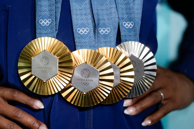 Simone Biles holds up her medals after the women's artistic gymnastics individual apparatus finals at the 2024 Summer Olympics on Monday, Aug. 5, 2024, in Paris, France.