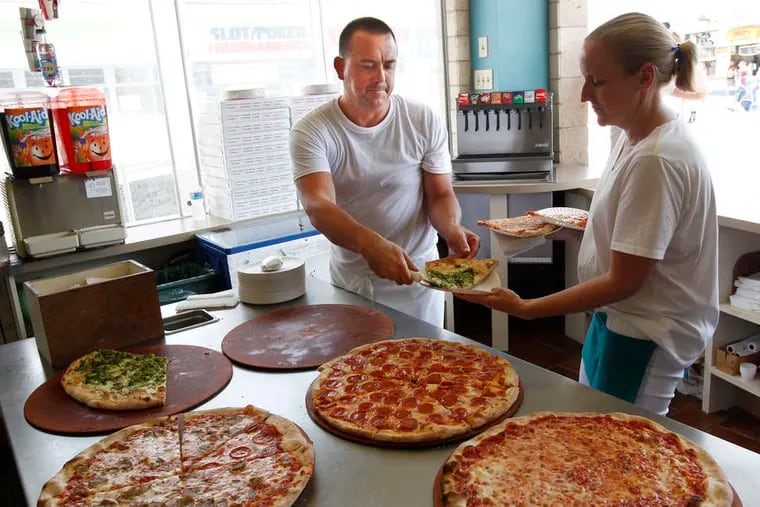 Sal Zuccarello hands a waitress her order at Sam's Pizza Palace in Wildwood. Pizza offers visitors a quick and tasty break from heavy restaurant meals .