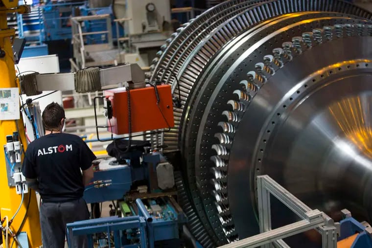 An Alstom employee works a turbine unit under construction inside Alstom SA's power-generation plant in Belfort, France. General Electric's chief executive officer, Jeffrey Immelt, said he is confident General Electric Co.'s $17 billion deal for Alstom SA's energy assets will win approval from European regulators. That's pivotal, because EU opposition helped scuttle GE's bid to purchase Honeywell International Inc. for $53 billion in 2001.