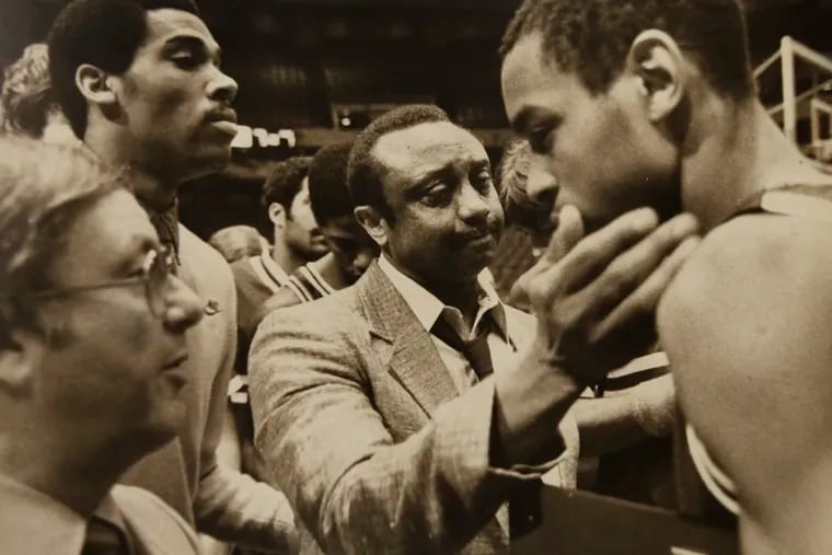 John Chaney, center, embraces Terence Stansbury, who was a third-team All-America honoree by the National Association of Basketball Coaches in 1984 and Chaney's first great player at Temple.