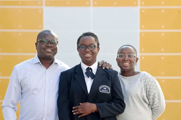 Moïra Koty-Couthon (center), 13, an eighth grader at the Mathematics, Civics and Sciences Charter School of Philadelphia, and parents Daniel Nansi and Romie Koty-Nansi were photographed near their home in Philadelphia on Sept. 21, 2022.