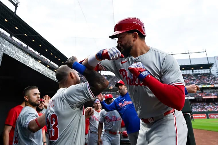 Kyle Schwarber (right) hit one of two Phillies' home runs on Friday night. The first was his 25th leadoff homer for the Phillies.
