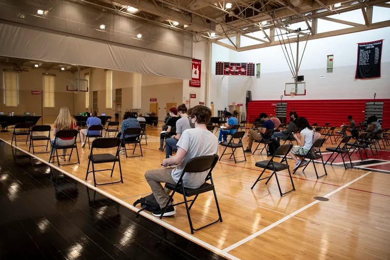 Faculty, staff, and students wait in the observation area after receiving their first COVID-19 vaccination shot at the Haverford College clinic in the athletic center in Haverford on Wednesday, April 13, 2021. Haverford is requiring vaccination for students in the fall semester.