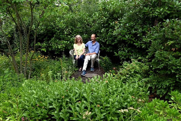 Jim Vick and Julie Miller Vick sit in a wrought iron love seat that was previously at Jim's parents' Haverford home.