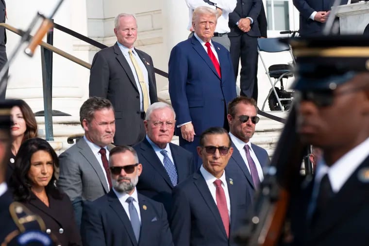 Bob Quackenbush, top left, deputy chief of staff for Arlington National Cemetery, and Republican presidential nominee former President Donald Trump watch the changing of the guard at the Tomb of the Unknown Solider on Monday, Aug. 26, 2024.