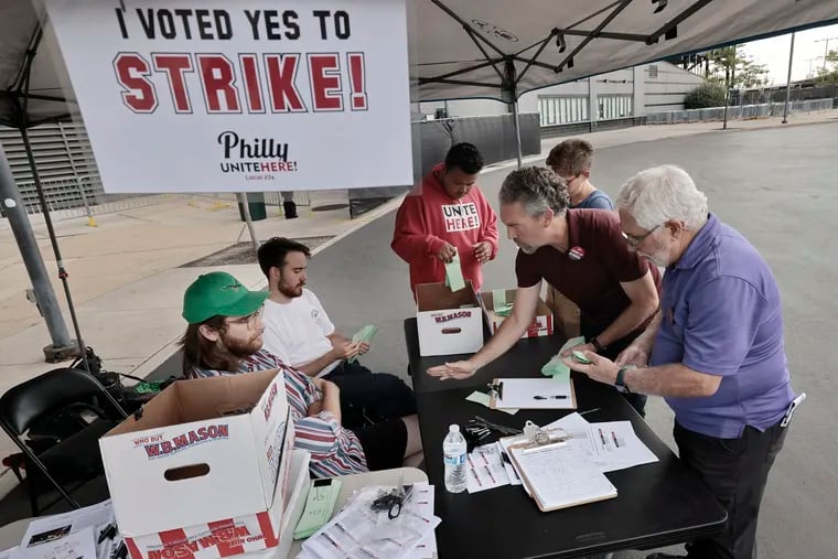 Unite Here organizer Ryan Nissim-Sabat (second from right) and union member John Dezio (far right) count the strike authorization ballots cast by Aramark workers at Lincoln Financial Field Friday before the watch party for the season opener between the Eagles and the Green Bay Packers, being played in Brazil. Union officials said 84% of those who voted approved going on strike if and when Unite Here Local 274 calls for it as contract negotiations continue. Strike authorization votes have also passed at Citizens Bank Park and Wells Fargo Center.