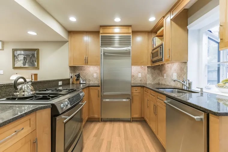 The renovated chef’s kitchen has granite countertops, custom cabinetry, a Subzero refrigerator, Bosch dishwasher, and JennAir stove with downdraft.