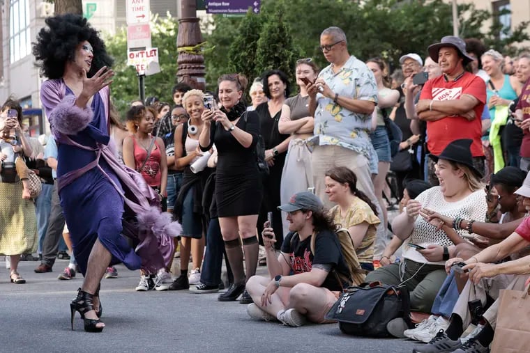 Drag performer Avery Goodname (left) of Philadelphia performs for people, on the last day of school, during the “Last Stand Jam” in front of the University of the Arts Dorrance Hamilton Hall on South Broad St. in Philadelphia on Friday.