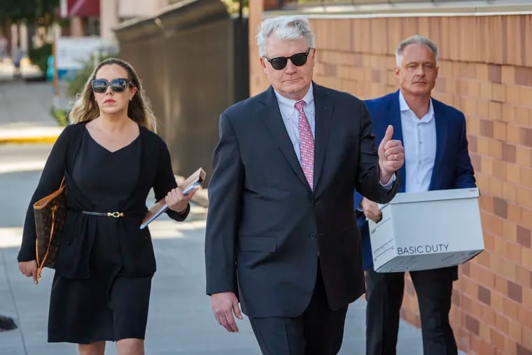 John Dougherty (center) arrives at the federal courthouse in Reading for his sentencing hearing in July.