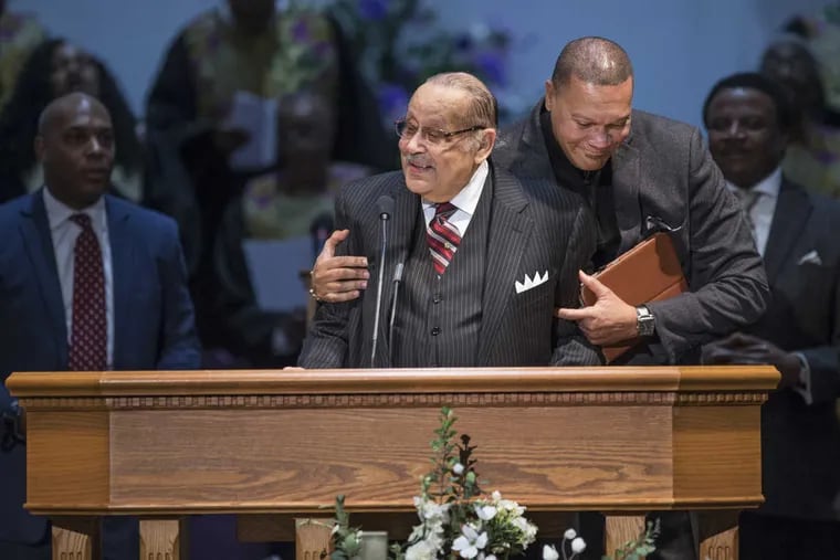 Rev. J.A. Jones, left, who is stepping down from the pulpit at Nazarene Baptist Chirch in Camden, NJ, gets a hug at the begining of the service from Rev. Gerrod Norman, right, on Sunday morning. Rev. J.A. Jones is known as &quot;The Bible Preacher&quot; because he believes that the teachings of the Bible never go out of style.