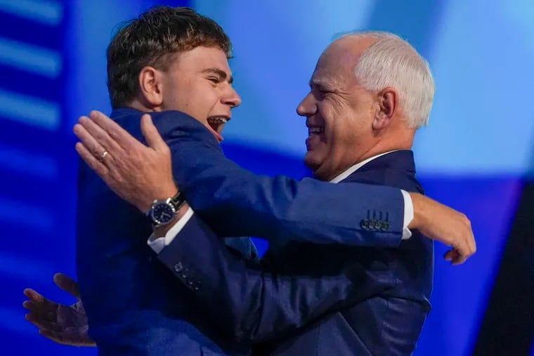 Democratic vice presidential nominee Minnesota Gov. Tim Walz hugs his son, Gus, during the Democratic National Convention in Chicago.