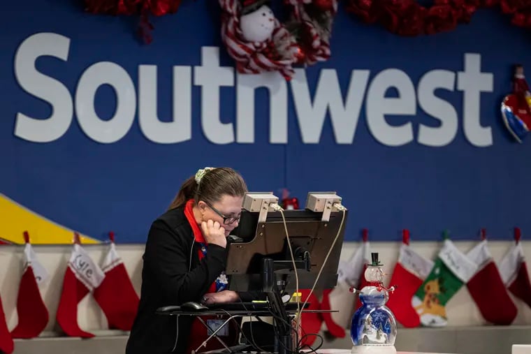 An airport ticket agent is shown on Tuesday at the Southwest Airlines terminal at Philadelphia International Airport.